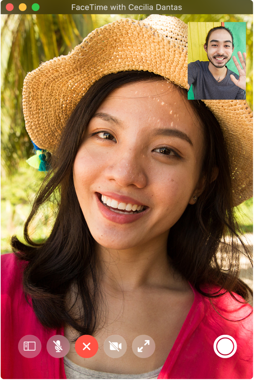The FaceTime window showing two people on a call; the person who made the call is in the picture-in-picture window in the upper-right corner. In the bottom-right corner is the Live Photo button, which either caller can click to capture a Live Photo of the moment.