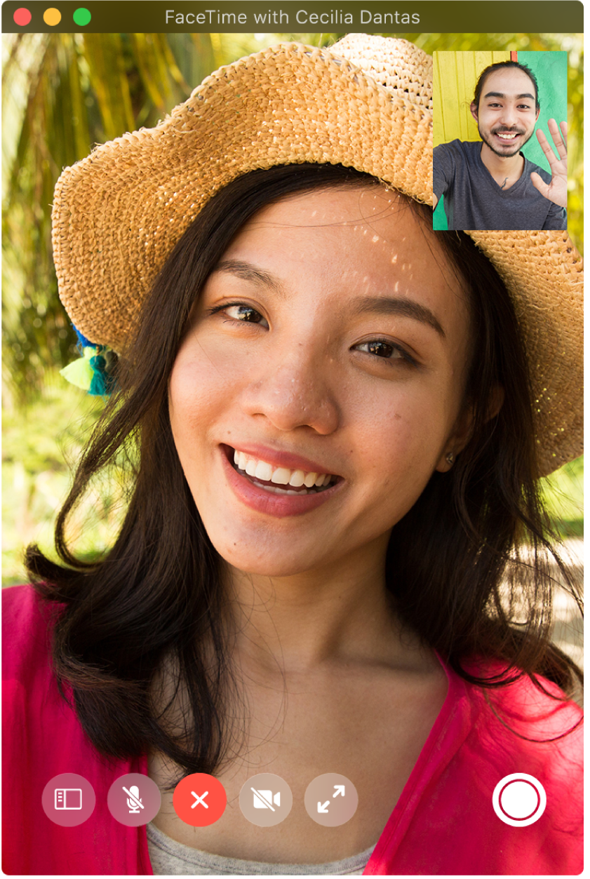The FaceTime window showing two people on a call; the person who made the call is in the picture-in-picture window in the upper-right corner. In the bottom-right corner is the Live Photo button, which either caller can click to capture a Live Photo of the moment.