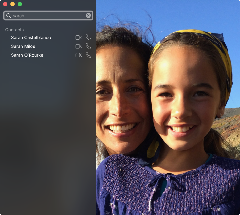 The FaceTime window before making a call. At the top left is a search field, with “Sarah” entered in the field, and below that is a list of search results showing contacts named Sarah, with buttons next to each contact that let you start a video or audio call. On the right is what your camera shows—two people ready to make a call.