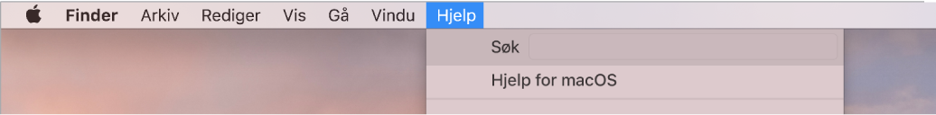 En del av et skrivebord med Hjelp-menyen åpen som viser menyvalgene Søk og Hjelp for macOS.
