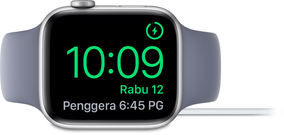Apple Watch diletakkan di sisi dan bersambung ke pengecas, dengan skrin menunjukkan simbol mengecas di penjuru atas kanan, masa semasa di bawahnya dan penggera di sebelahnya.