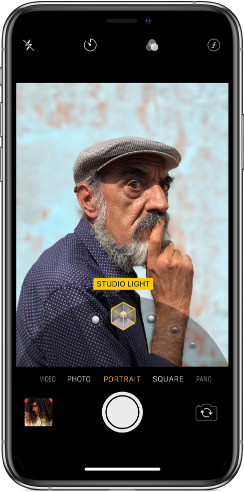 The Camera screen with Portrait mode selected. In the viewer, a box shows that the Portrait Lighting option is set to Studio Light, and there’s a slider to change the studio lighting option.