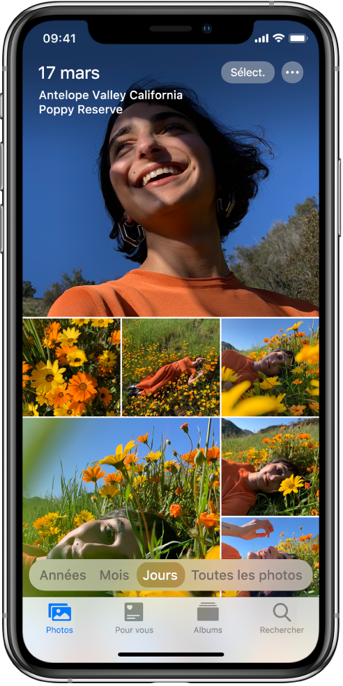 La présentation Jours de la photothèque est affichée. Une sélection de vignettes de photos remplit l’écran. En haut à gauche de l’écran se trouvent la date et l’emplacement des photos prises. En haut à droite se trouvent les boutons Sélectionner et « Plus d’options » : touchez Sélectionner pour partager les photos et « Plus d’options » pour afficher les détails des photos. Sous les vignettes se trouvent des options de présentation de la photothèque : Années, Mois, Jours et « Toutes les photos ». En bas se trouvent les onglets Photos, « Pour vous », Albums et Rechercher.