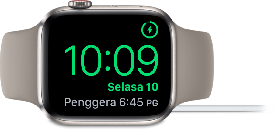 Apple Watch diletakkan di sisi dan bersambung ke pengecas, dengan skrin menunjukkan simbol mengecas di penjuru atas kanan, masa semasa di bawahnya dan penggera di sebelahnya.