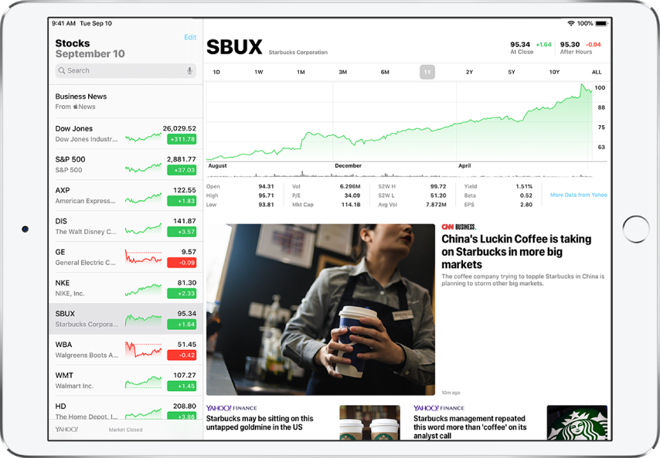 The Stocks screen in landscape orientation. The search field is in the top-left corner. Below the search field is the watchlist. A stock in the watchlist is selected. In the middle of the screen a chart shows the performance of the selected stock over the course of one year. Above the chart are buttons to display the stock performance by one day, one week, one month, three months, six months, one year, two years, five years, or ten years. Below the chart are stock details such as opening price, high, low, and market cap. Below the chart details are Apple News articles related to stock.