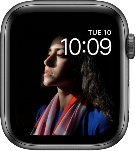The Photos watch face shows a photo from your synced photo album. The face shows the date above the time.