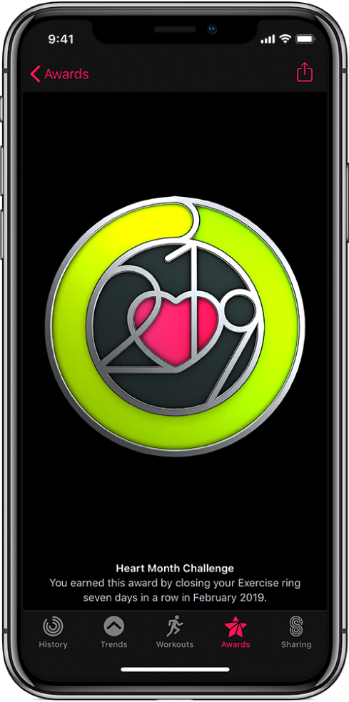 The Awards tab of the Activity app screen on iPhone, showing an achievement award in the middle of the screen. You can drag to rotate the award. The Share button is at the top right.