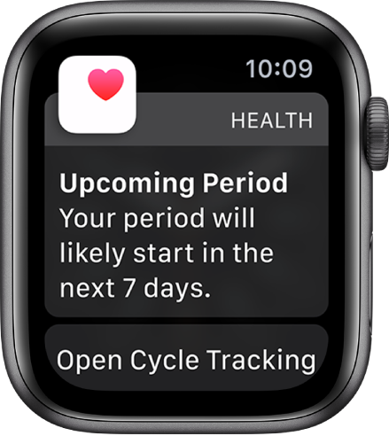 „Apple Watch“ su mėnesinių prognozės ekranu, kuriame rodomas pranešimas „Netrukus prasidės mėnesinės. Tikėtina mėnesinių pradžia per 7 dienas“. Apačioje rodomas programos „Cycle Tracking“ atidarymo mygtukas.