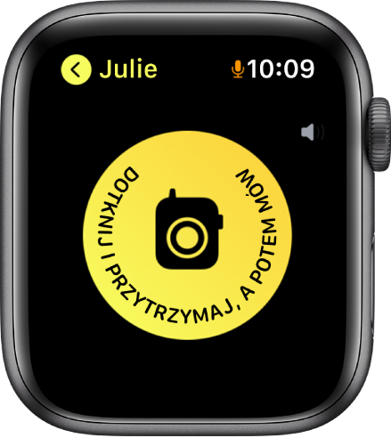 Ekran aplikacji Walkie‑Talkie z przyciskiem Mów na środku oraz wskaźnikiem głośności w prawym górnym rogu. Obok godziny, w prawym górnym rogu widoczna jest mała ikona mikrofonu, która oznacza, że mikrofon jest aktualnie używany.