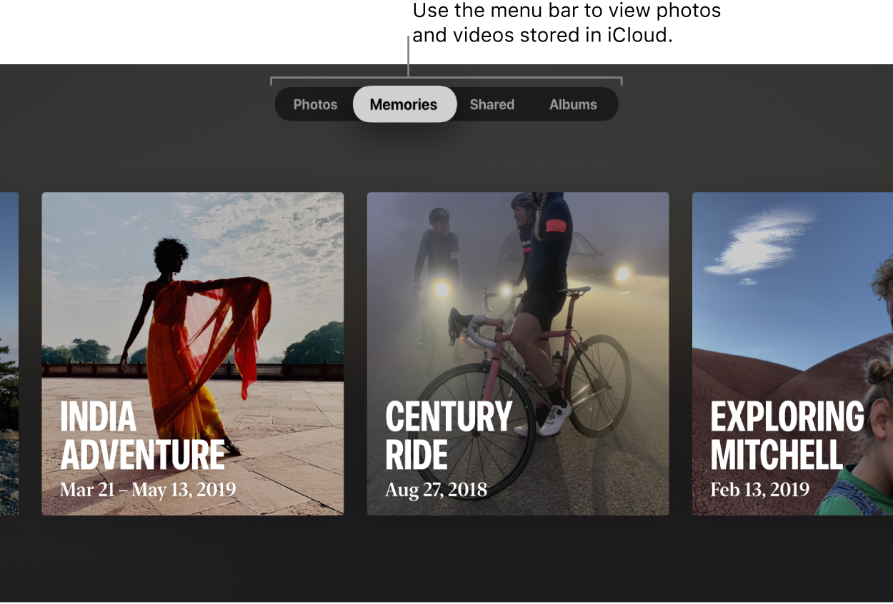 The Photos app on an Apple TV. A line points to the menu bar, showing four options: Photos, Memories (selected), Shared, and Albums. The callout says: “Use the menu bar to view photos and videos stored in iCloud.” Three Memories are visible: India Adventure, Century Ride, and Exploring Mitchell.