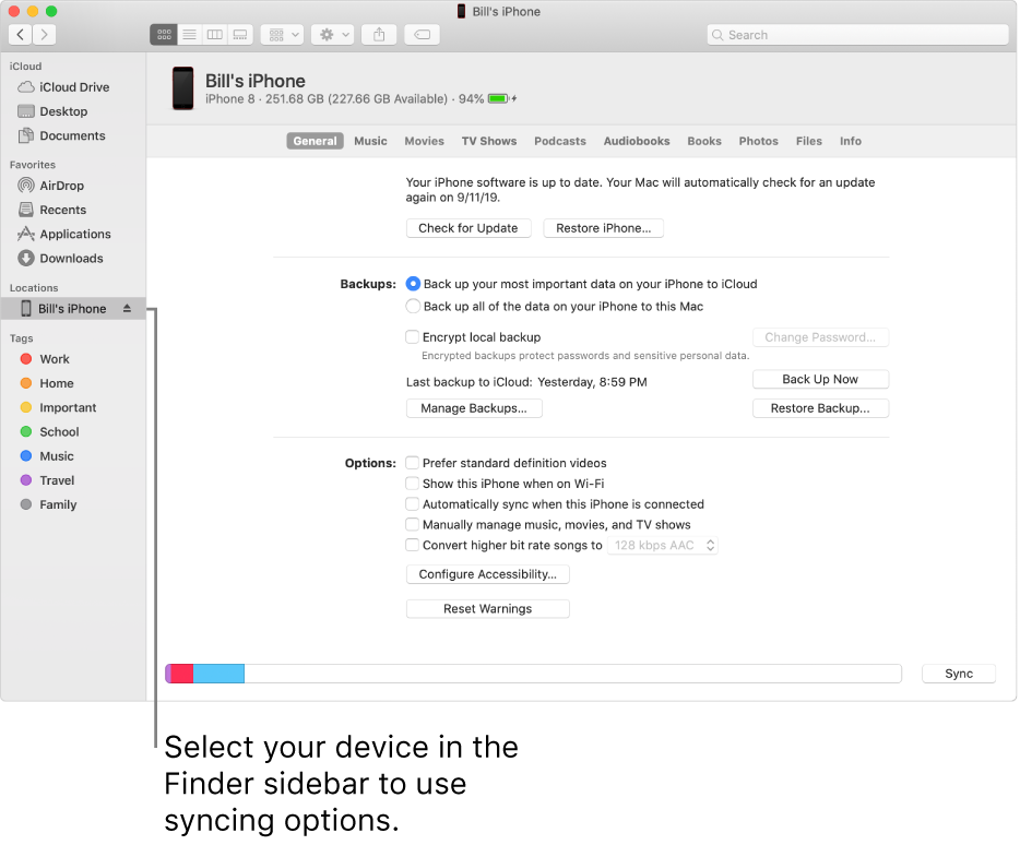 A device selected in the Finder sidebar and syncing options appearing in the window.