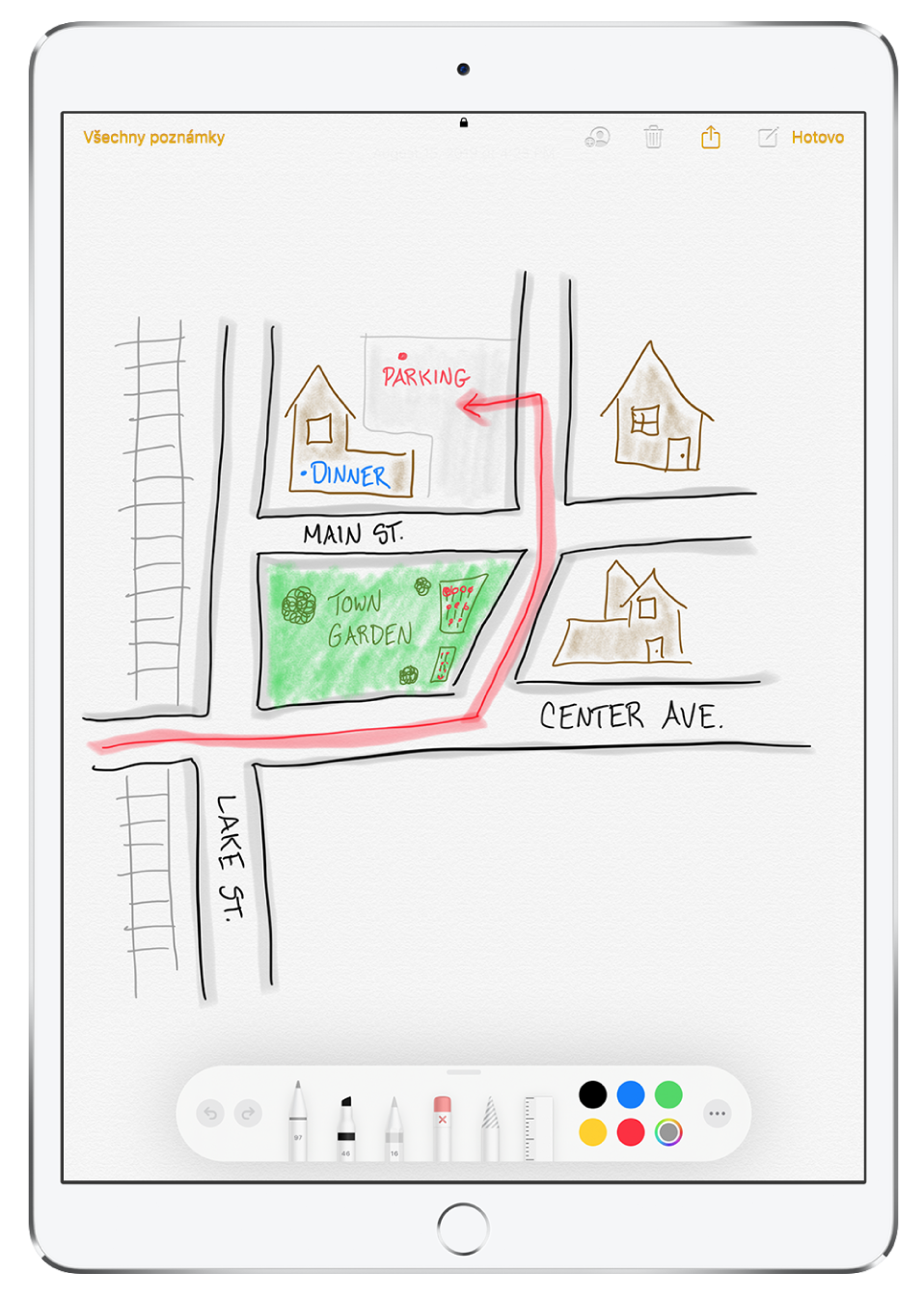 Náčrtek plánu ulic v poznámce v aplikaci Poznámky. Na kresbě jsou označené ulice a červená šipka ukazuje, kde se dá zaparkovat. U dolního okraje obrazovky se nachází panel nástrojů Anotace s psacími potřebami a vybranou vlastní barvou.