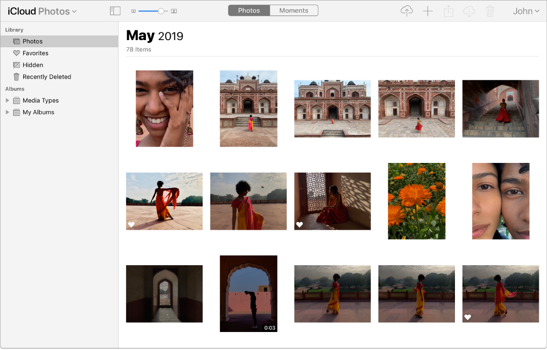 App Foto di iCloud.com. Foto dipilih di bar samping dan foto dari bulan Mei 2019 dapat dilihat.