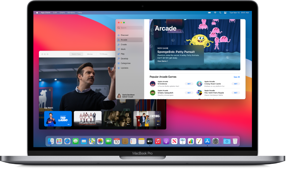 A Mac desktop with the Apple TV app showing The Watch Now screen and the App Store app showing Apple Arcade.