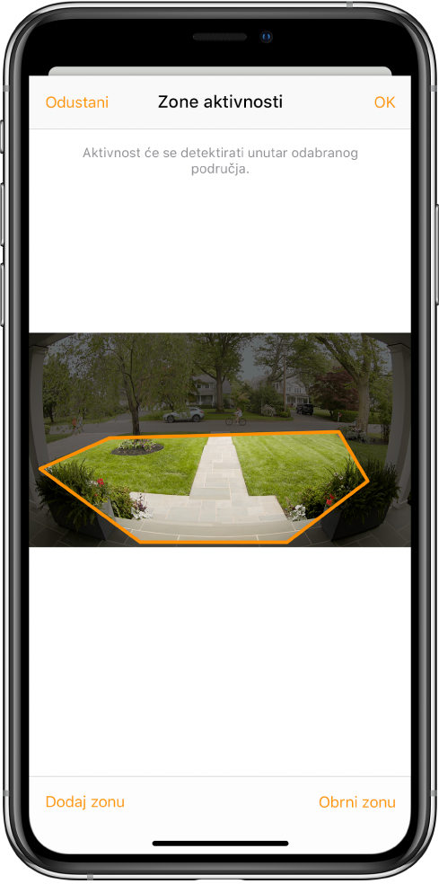 Zaslon iPhonea koji prikazuje zonu aktivnosti unutar slike snimljene kamerom na vratima. Zona aktivnosti obuhvaća prednji trijem i nogostup, ali isključuje ulicu i prilaz. Tipke Poništi i OK su iznad slike. Tipke Dodaj zonu i Obrni zonu su ispod.