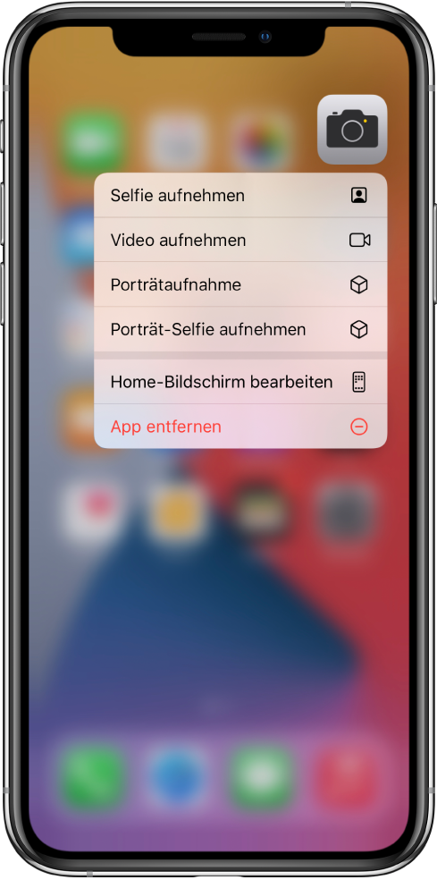 Im Hintergrund befindet sich der weichgezeichnete Home-Bildschirm mit dem Menü für Kamera-Schnellaktionen unter der App „Kamera“.