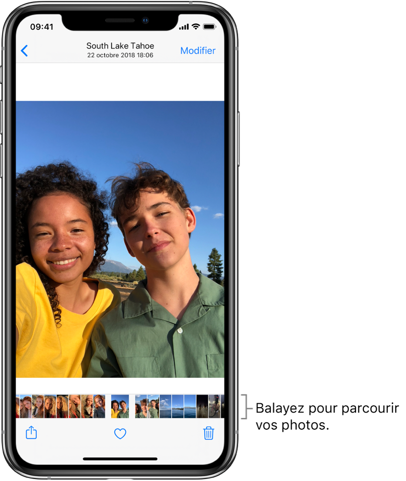 Une photo, avec les vignettes d’autres photos au bas de l’écran. En haut à gauche, le bouton Retour permet de revenir à l’affichage que vous étiez en train de parcourir. En bas, vous trouverez les boutons Partager, Aimer et Supprimer. En haut à droite se trouve le bouton Modifier.