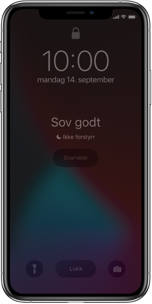 iPhone-skjermen viser «Sov godt» og «Ikke forstyrr er på» i midten. Under vises Snarveier-knappen. Nederst på skjermen, fra venstre til høyre, er Lommelykt-, Lukk- og Kamera-knappene.