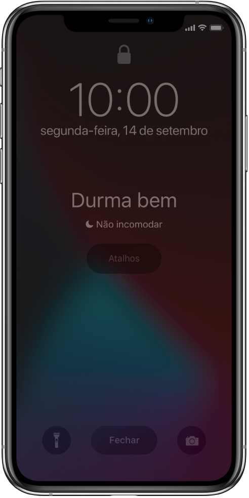 O ecrã do iPhone a mostrar “Durma bem” e “Não incomodar está ativado” ao centro. Por baixo, encontra-se o botão Atalhos. Na parte inferior do ecrã, da esquerda para a direita, encontram-se os botões Lanterna, Ignorar e Câmara.