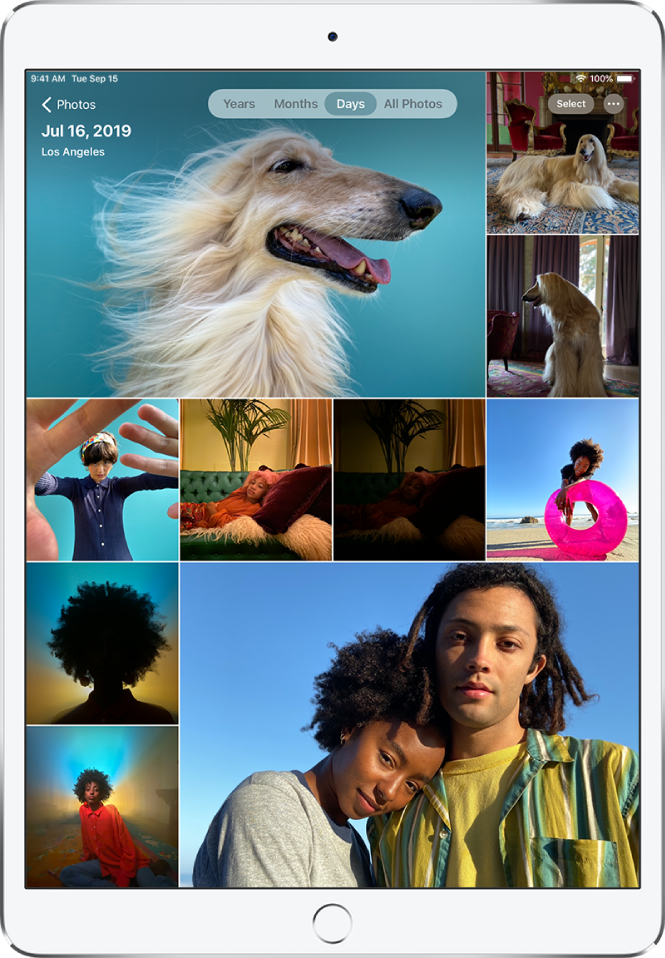 The photo library displayed in Days view. A selection of photo thumbnails fills the screen. In the top left of the screen is the Photos button to open the sidebar. Below the Photos button is the date and location where the photos displayed on the screen were taken. In the top center are options to browse photos by Years, Months, Days, or All Photos; Days is selected. In the top right of the screen are the Select and More Options buttons.