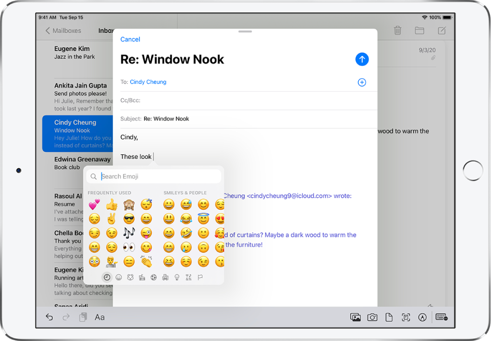 An email reply appears onscreen. The emoji keyboard appears at the text insertion point.