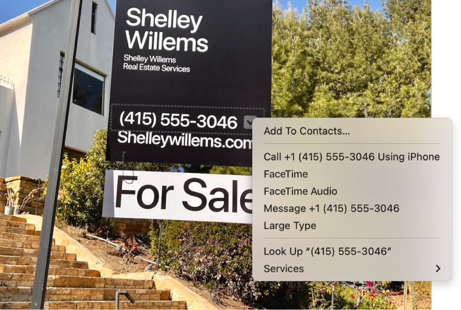 Photo of a real estate For Sale sign showing the agent’s phone number selected as Live Text and a menu presenting options to add the phone number to Contacts, call the number, start a FaceTime call, send a text message, and more.