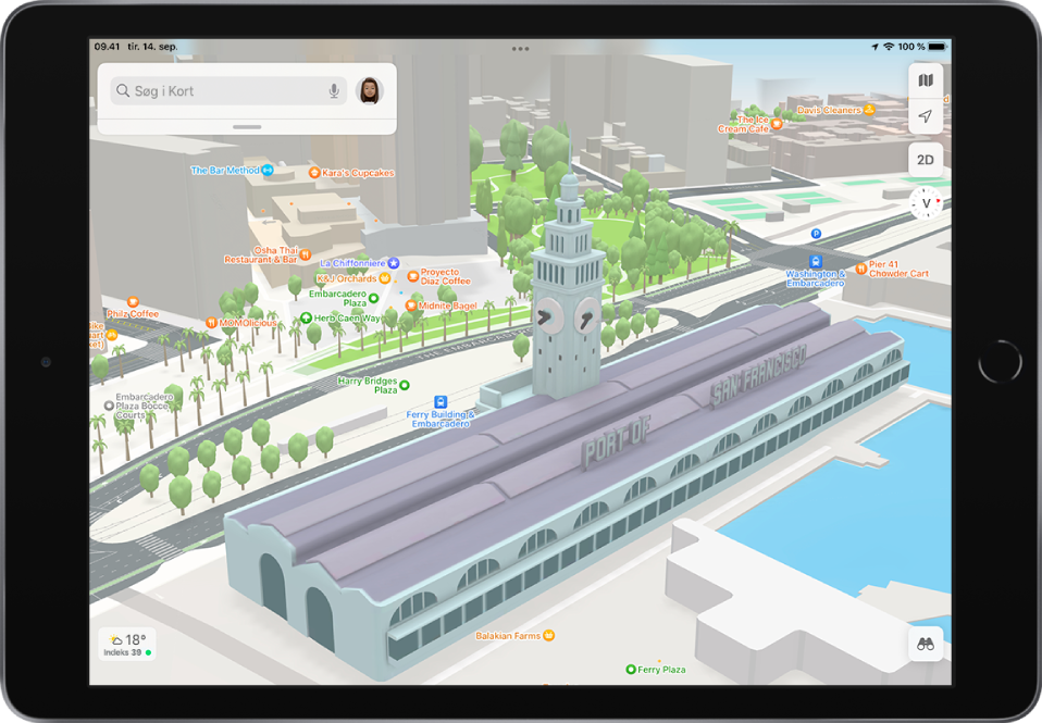Et bykort i 3D, der viser bygninger, gader og en park.