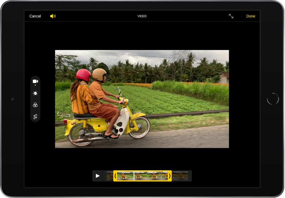 A video is in the Edit screen and the video frame viewer is across the bottom of the screen. The Cancel and Volume buttons are in the top-left corner and the Enter Full Screen and Done buttons are in the top-right corner. The editing tools are on the left side of the screen: from the top to bottom, Video, Adjust, Filters, and Crop. Video is selected.