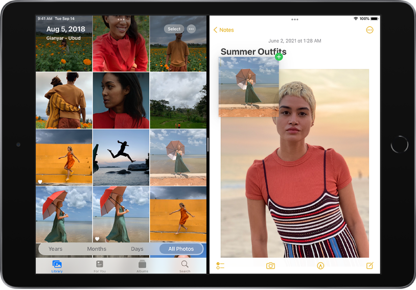 The iPad screen in landscape orientation and in Split View. On the left side of the screen is the Photos app library. On the right side of the screen is an open note in the Notes app. The title of the note is Summer Outfits and a photo is in the center of the note. Above the photo is a thumbnail of another photo being dragged from the photo library on the left side of the screen to the drawing area of the note on the right side of the screen.