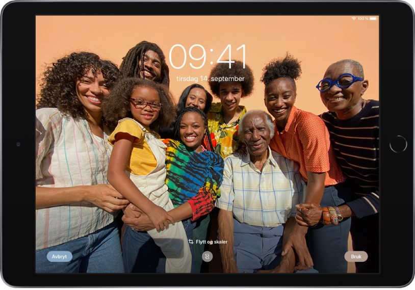 Låst skjerm på iPad med et bilde fra bildebiblioteket som bakgrunn.
