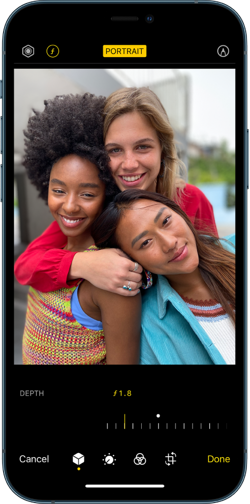 The Edit screen of a Portrait mode photo. At the top left of the screen is the Lighting Intensity button and the Depth Adjustment button. At the top center of the screen the Portrait button is on and at the top right is the Plug-ins button. The photo is in the center of the screen and below the photo is a slider to adjust the Depth Adjustment setting. Below the slider from left to right are the Cancel, Portrait, Adjust, Filters, Crop, and Done buttons.