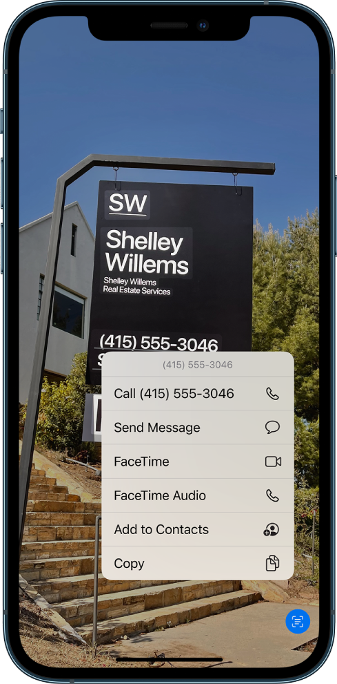 A photo is open on the entire screen. Within the photo is a sign that includes text and a phone number. The phone number is selected and the following options are available on the screen: Call, Send Message, FaceTime, FaceTime Audio, Add to Contacts, and Copy.