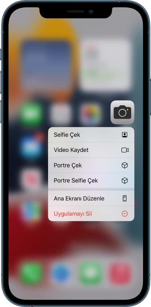Ana ekran bulanıklaşır, Kamera uygulamasının altında Kamera’nın hızlı eylem menüsü görünür.