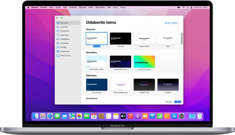 MacBook Pro s otvorenim izbornikom tema aplikacije Keynote na zaslonu. Kategorija Sve teme odabrana je s lijeve strane, a postojeće teme pojavljuju se s desne u recima po kategoriji. Skočni izbornik Jezik i Regija u donjem lijevom kutu i skočni izbornik Standardno i Široko u gornjem desnom kutu.