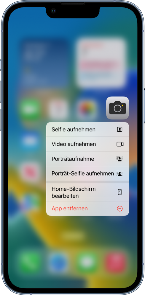 Im Hintergrund befindet sich der weichgezeichnete Home-Bildschirm mit dem Menü für Kamera-Schnellaktionen unter der App „Kamera“.