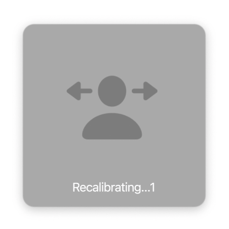 The on-screen countdown for head pointer recalibration, showing “Recalibrating…1.”