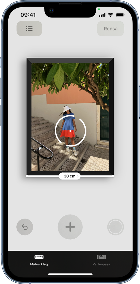 Ett inramat pappersfoto mäts och bredden visas längs nederkanten. Knappen Ta bild finns i det undre högra hörnet. Den gröna indikatorn Kameran används visas högst upp till höger.