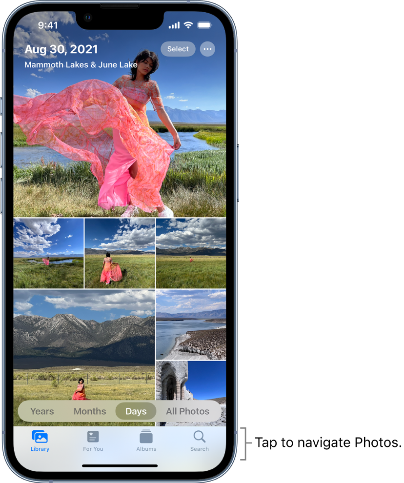 The photo library displayed in Days view. A selection of photo thumbnails fills the screen. In the top left of the screen are the date and location where the photos were taken. In the top right are the Select and More Options buttons to share photos and see details. Below the thumbnails are options to view the photo library by Years, Months, Days, and All Photos. Along the bottom are the Library, For You, Albums, and Search buttons.
