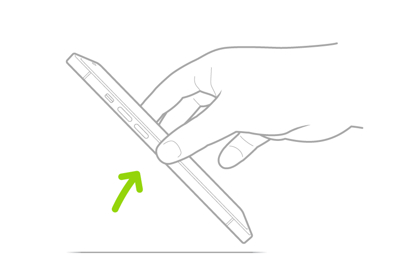 Uma mão erguendo o iPhone de uma superfície plana.