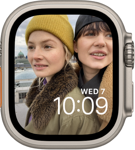 The Photos watch face shows a photo from your synced photo album. The date and time is near the bottom right.