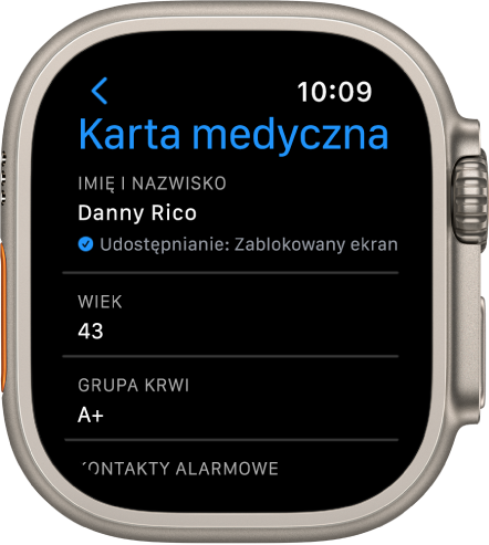 Ekran karty medycznej na Apple Watch, wyświetlający imię, nazwisko, wiek oraz grupę krwi użytkownika. Poniżej nazwiska widoczna jest ikona zaznaczenia, która oznacza, że karta medyczna jest udostępniana na zablokowanym ekranie. Przycisk Gotowe znajduje się w lewym górnym rogu.