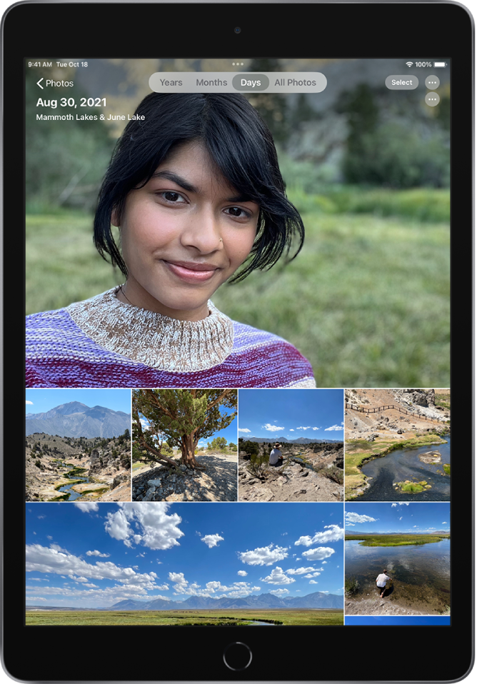 The photo library displayed in Days view. A selection of photo thumbnails fills the screen. In the top left of the screen is the Photos button to open the sidebar. Below the Photos button is the date and location where the photos displayed on the screen were taken. In the top center are options to browse photos by Years, Months, Days, or All Photos; Days is selected. In the top right of the screen are the Select and More Options buttons.
