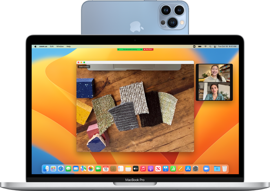A MacBook Pro using an iPhone camera to enable Desk View and showing a FaceTime session.
