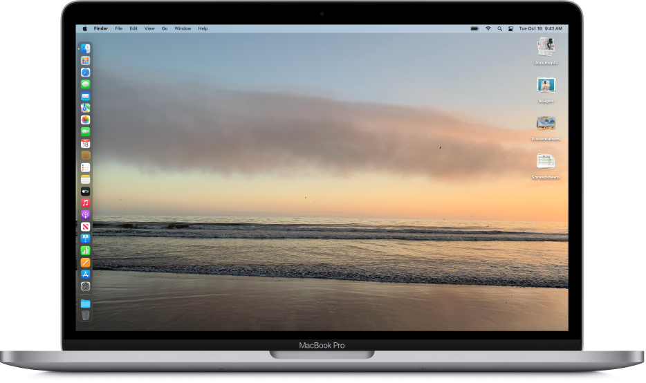 The desktop with a photo of an ocean shore set as the desktop picture. The Dock appears on the left and several stacks of documents appear on the right.