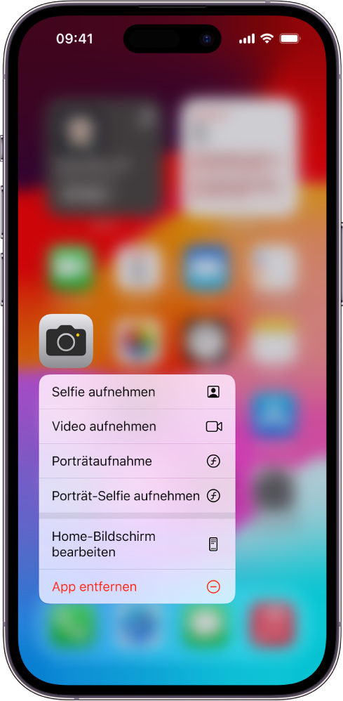 Der weichgezeichnete Home-Bildschirm mit dem Menü für Kamera-Schnellaktionen unter dem Symbol der App „Kamera“.