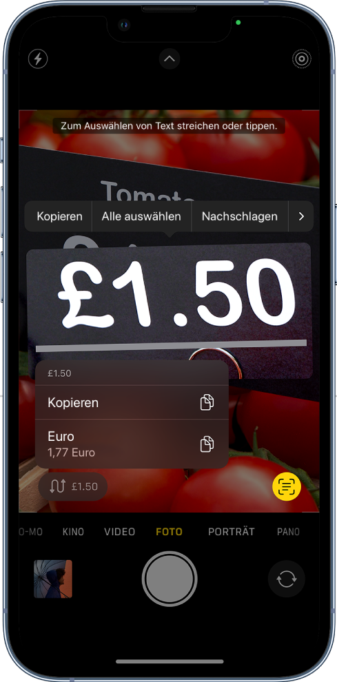 Der Bildschirm der App „Kamera“ mit der Schnellaktionstaste zum Umrechnen einer Währung, die innerhalb des Kamerarahmens angezeigt wird.
