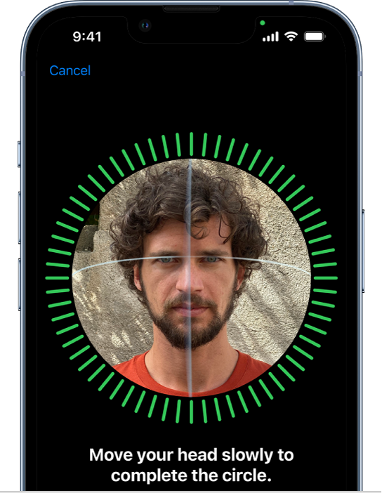 The Face ID recognition setup screen. A face is shown on the screen, enclosed in a circle. Text below the face instructs the user to move their head slowly to complete the circle.