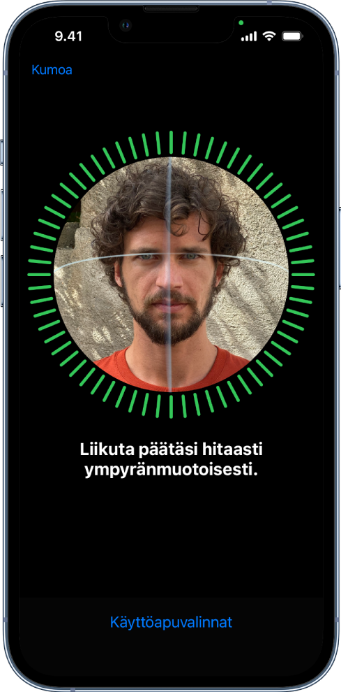 Face ID ‑tunnistuksen käyttöönottonäyttö. Näytöllä näkyvät kasvot, jotka ovat ympyrän sisällä. Alapuolella oleva teksti neuvoo käyttäjää liikuttamaan päätä hitaasti ympyränmuotoisesti. Lähellä näytön alareunaa on Käyttöapuvalinnat-painike.
