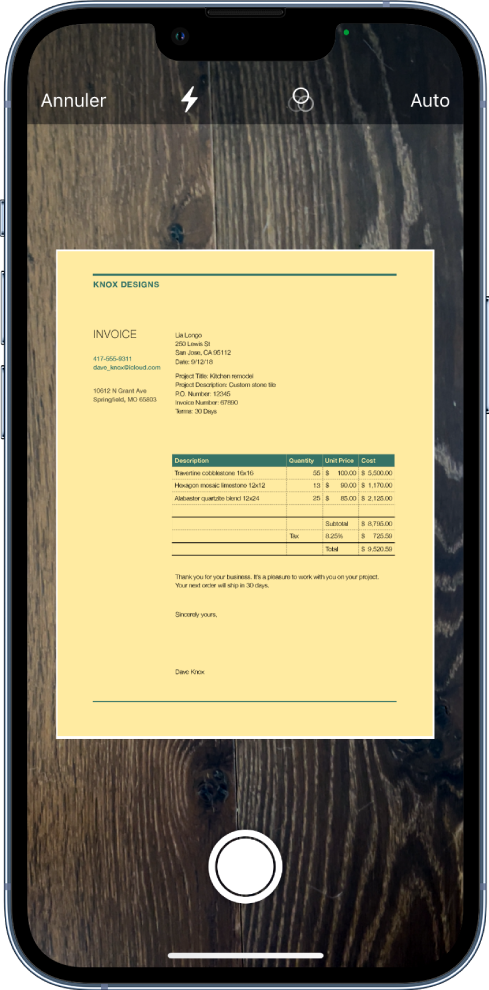 Un écran affichant un document en cours de numérisation. Le bouton de prise de photo est situé en bas au centre.