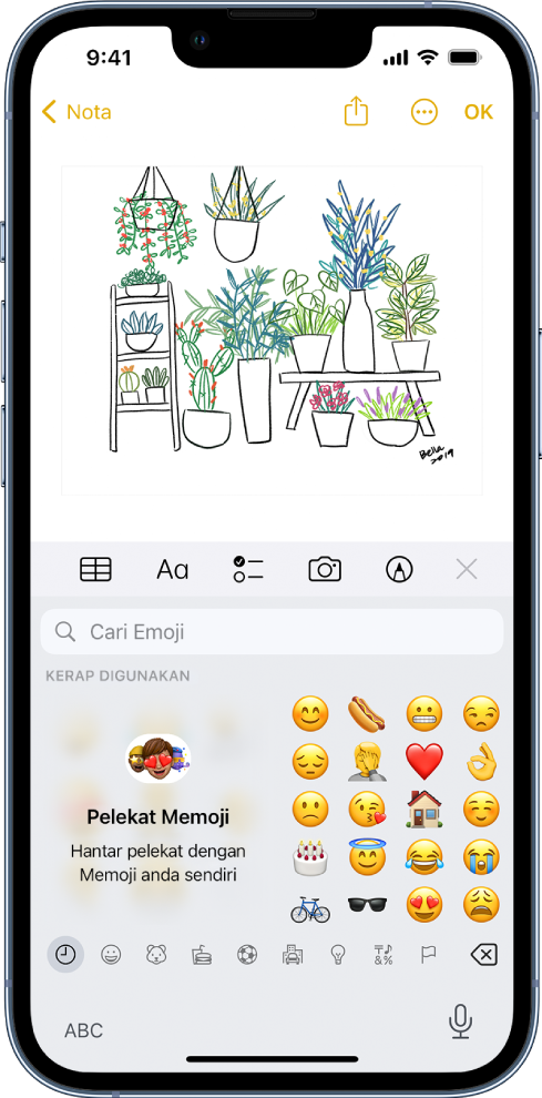 Nota dalam app Nota sedang diedit, dengan papan kekunci emoji terbuka dan medan Cari Emoji di bahagian atas papan kekunci.